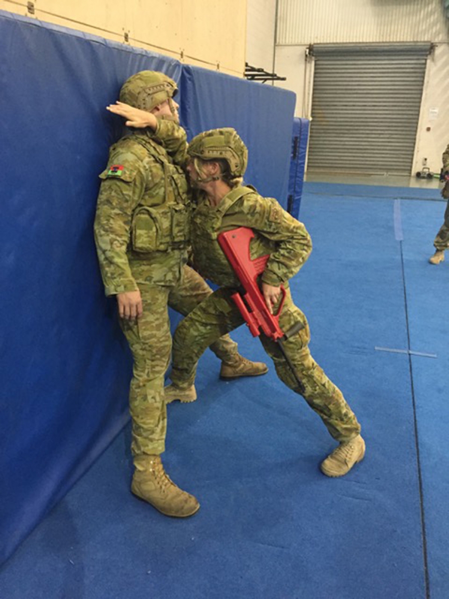 Soldier practising wall domination during a lesson in the Australian Army Combatives Program (ACP)