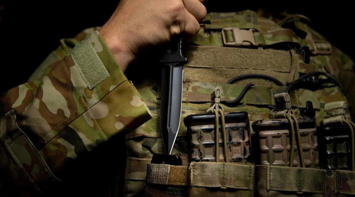 Australian soldier carrying clearing knife